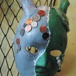 A decorative mask made by a Fireweed Academy student hangs in K-Bay Caffe during an art exhibit opening on Thursday, March 5, 2020 in Homer, Alaska. The masks were made with the help of Artist in the Schools participant Gail Baker. (Photo by Megan Pacer/Homer News)