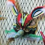 A decorative mask made by a Fireweed Academy student hangs in K-Bay Caffe during an art exhibit opening on Thursday, March 5, 2020 in Homer, Alaska. The masks were made with the help of Artist in the Schools Program participant Gail Baker. (Photo by Megan Pacer/Homer News)