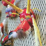 A decorative mask made by a Fireweed Academy student hangs in K-Bay Caffe during an art exhibit opening on Thursday, March 5, 2020 in Homer, Alaska. The masks were made with the help of Artist in the Schools participant Gail Baker. (Photo by Megan Pacer/Homer News)