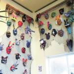 Decorative masks made by Fireweed Academy students hang in K-Bay Caffe during an art exhibit opening on Thursday, March 5, 2020 in Homer, Alaska. The masks were made with the help of Artist in the Schools Program participant Gail Baker. (Photo by Megan Pacer/Homer News)