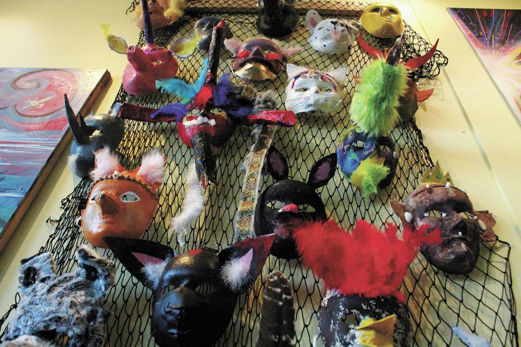 Decorative masks made by Fireweed Academy students hang in K-Bay Caffe during an art exhibit opening on Thursday, March 5, 2020 in Homer, Alaska. The masks were made with the help of Artist in the Schools Program participant Gail Baker. (Photo by Megan Pacer/Homer News)