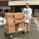 Kachemak Bay Campus Director Reid Brewer moves boxes of personal protective gear from the college for transport to South Peninsula Hospital on March 25, 2020, in Homer, Alaska. (Photo courtesy Susan Kaplan)