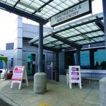 Signs on Saturday, March 28, 2020, at the main entrance to South Peninsula Hospital in Homer, Alaska, warn visitors not to enter until they have been met by hospital staff. (Photo by Michael Armstrong/Homer News)