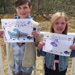 Logan Cote, left, and Reese Cote, left, of Brookline, New Hampshire, hold up art they drew from the Salmon Sisters coloring pages while out of school in March during the COVID-19 pandemic. Their great aunt, Jenny Stroyeck, sent them the pages. Stroyeck is the wife of Homer News editor Michael Armstrong. (Photo courtesy Alana Cote)