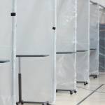 Patient bays separated by thick walls of plastic sit all in a line in Christian Community Church on Monday, April 6, 2020 in Homer, Alaska. The church is the alternate care site for South Peninsula Hospital where overflow of future COVID-19 patients will be treated. (Photo by Megan Pacer/Homer News)