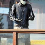 The statue of Brother Asaiah Bates that stands at Cosmic Kitchen is seen wearing a mask on Monday, April 6, 2020 in Homer, Alaska. The state of Alaska is currently advising people to wear protective cloth coverings when they have to go out in public for essentials. (Photo by Megan Pacer/Homer News)