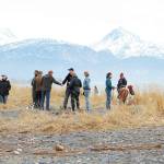 Two people shake hands at a community gathering and barbecue at the beach Saturday, April 18, 2020 at Mariner Park in Homer, Alaska. The event was hosted by Homers Sons of Liberty to assert the right to assemble. Organizers said attendees were encouraged to practice social distancing guidelines. (Photo by Megan Pacer/Homer News)