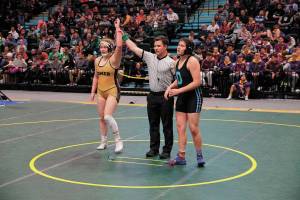 Rayana Vigil, left, celebrates a victorious bout during the 2019 ASAA/First National Bank Alaska Wrestling State Championships in Anchorage, Alaska. Vigil was crowned the womens state champion for the 189-pound weight class. (Photo courtesy Alaska School Activities Association)