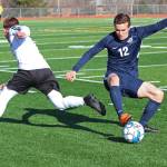 Homers Daniel Reutov snags the ball from a Kenai player during a soccer game on April 16, 2019 at Homer High School in Homer, Alaska. (Photo by Megan Pacer/Homer News)