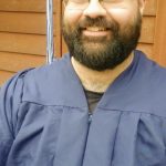 Trevor Earll, a 2020 graduate and valedictorian at Kenai Peninsula College, poses in a cap and gown for a virtual commencement ceremony, May 7, 2020. (Photo courtesy of Trevor Earll)