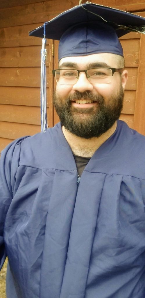 Trevor Earll, a 2020 graduate and valedictorian at Kenai Peninsula College, poses in a cap and gown for a virtual commencement ceremony, May 7, 2020. (Photo courtesy of Trevor Earll)