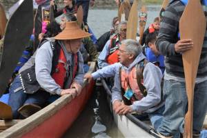Courtesy photo | Alaskas Digital Archives                                 Then-Gov. Bill Walker and then-Lt. Governor Byron Mallott speak across Tlingit canoes amid canoe events for Celebration 2016.