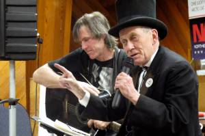 Photo by Mark Thiessen | associated press file                                Mayor Richard Beneville reads poetry to volunteers and fans at the Iditarod Trail Sled Dog Race headquarters in Nome in March 2012.