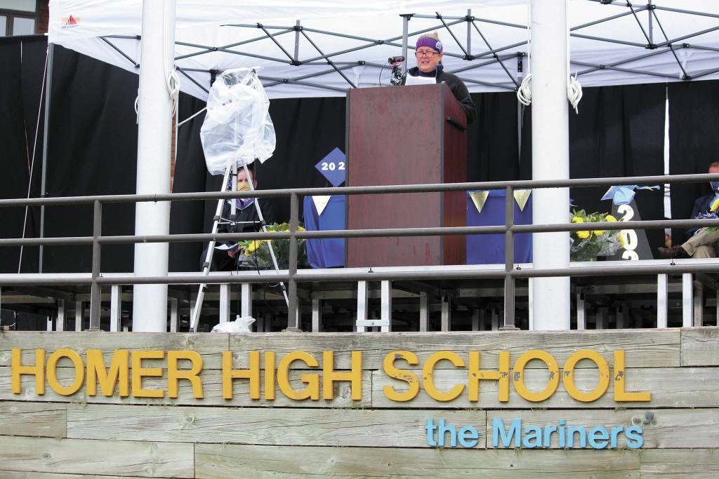 Pam Ruglowski gives part of the commencement address at Homer High Schools graduation ceremony Monday, May 18, 2020 on a stage set up outside the school in Homer, Alaska. (Photo by Megan Pacer/Homer News)