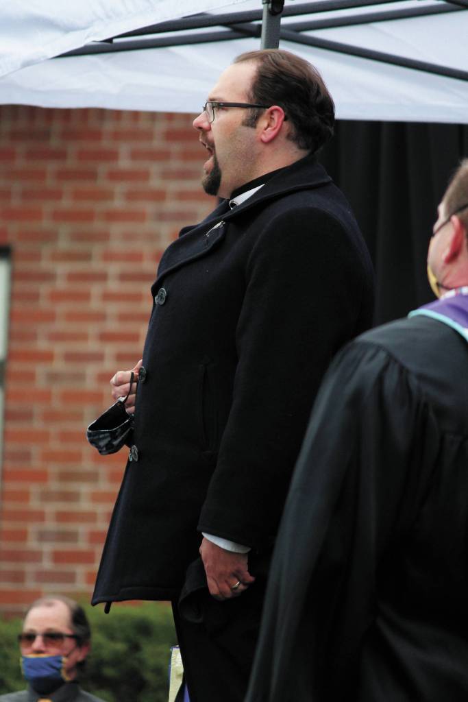 Kyle Schneider, director of choirs for Homer High School and Homer Middle School, sings the national anthem at Homer High Schools Monday, May 18, 2020 graduation ceremony at the school in Homer, Alaska. (Photo by Megan Pacer/Homer News)