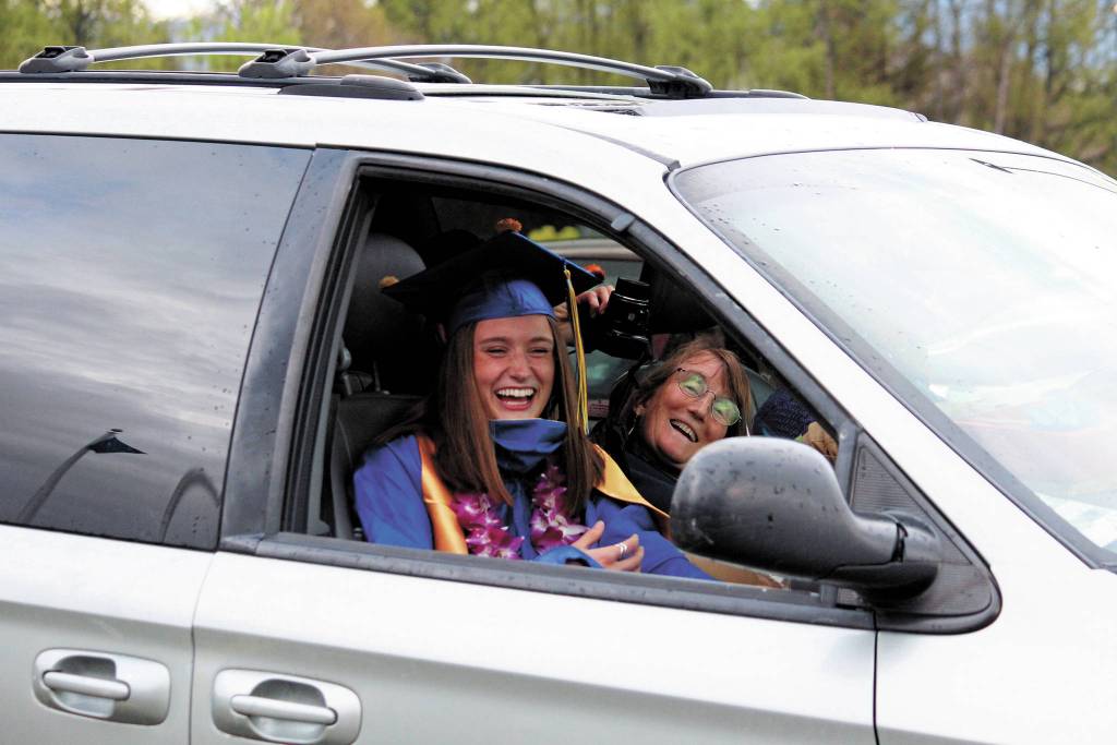 Homer High School graduate Autumn Daigle celebrates with her mom once back in their vehicle during the schools Monday, May 18, 2020 drive-through commencement ceremony in Homer, Alaska. (Photo by Megan Pacer/Homer News)