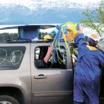 Graduate Colby Marion moves the tassel on a giant graduation cap atop his familys vehicle after collecting his diploma at Homer High Schools drive-through commencement ceremony Monday, May 18, 2020 at the school in Homer, Alaska. (Photo by Megan Pacer/Homer News)