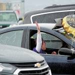 Graduate Audnia Carlson celebrates out her car window during a Monday, May 18, 2020 commencement ceremony for Homer Flex School at the Homer Harbor in Homer, Alaska. (Photo by Megan Pacer/Homer News)