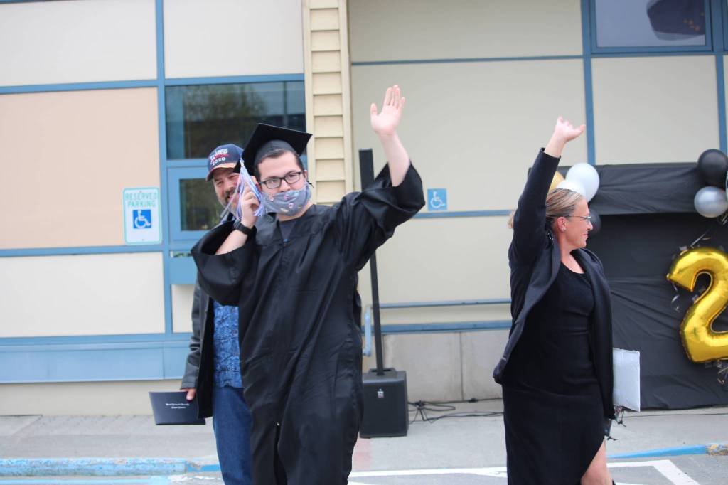 Graduate Jonathan Ham walks with his family back to his car after receiving his diploma during the Connections Homeschool Class of 2020 graduation at Soldotna Elementary School.