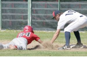 Post 20 first baseman Seth Adkins tags out Axel Shanks of Napoleon (Ohio) Post 300 on Wednesday, July 3, 2019, at Coral Seymour Memorial Park in Kenai, Alaska. Twins pitcher Mose Hayes picked off Shanks. (Photo by Jeff Helminiak/Peninsula Clarion)