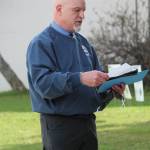 Ninilchik School Principal Jeff Ambrosier reads the scholarships graduates received during an alternative graduation ceremony outside the school Wednesday, May 20, 2020 in Ninilchik, Alaska. (Photo by Megan Pacer/Homer News)