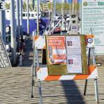 Signs at the Homer Harbor advise harbor users and visitors of COVID-19 information and resources on Sunday, May 24, 2020, in Homer, Alaska. (Photo by Michael Armstrong/Homer News)