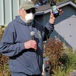 Robert Archibald auctions off one of the last two bottles of limited edition beer created by Grace Ridge Brewery to celebrate the 50th anniversary of Kachemak Bay State Park during a gathering Saturday, June 6, 2020 at the Homer Chamber of Commerce & Visitor Center in Homer, Alaska. (Photo by Megan Pacer/Homer News)