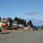 A driver heads west on Pioneer Avenue at Svedlund Street on Monday, June 22, 2020, in Homer, Alaska. A retaining wall at the intersection in front of the Pioneer Car Wash was moved back and a utility pole removed to create a better sight line at the corner, part of a repaving project for Pioneer Avenue. (Photo by Michael Armstrong/Homer News)