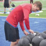 Soldotna football player Zac Buckbee disinfects a smash ball Wednesday, June 17, 2020, at Justin Maile Field in Soldotna, Alaska. (Photo by Jeff Helminiak/Peninsula Clarion)