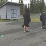 Soldotna football players wait in line to get screened by head coach Galen Brantley Jr. before summer workouts Wednesday, June 17, 2020, at Soldotna High School in Soldotna, Alaska. (Photo by Jeff Helminiak/Peninsula Clarion)