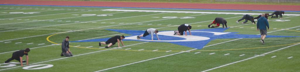 Soldotna football head coach Galen Brantley Jr. takes players through drills for sprint mechanics Wednesday, June 17, 2020, at Justin Maile Field at Soldotna High School in Soldotna, Alaska. (Photo by Jeff Helminiak/Peninsula Clarion)