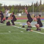 Soldotna assistant football coach Eric Pomerleau leads players through strength and mobility drills Wednesday, June 17, 2020, at Justin Maile Field at Soldotna High School in Soldotna, Alaska. (Photo by Jeff Helminiak/Peninsula Clarion)