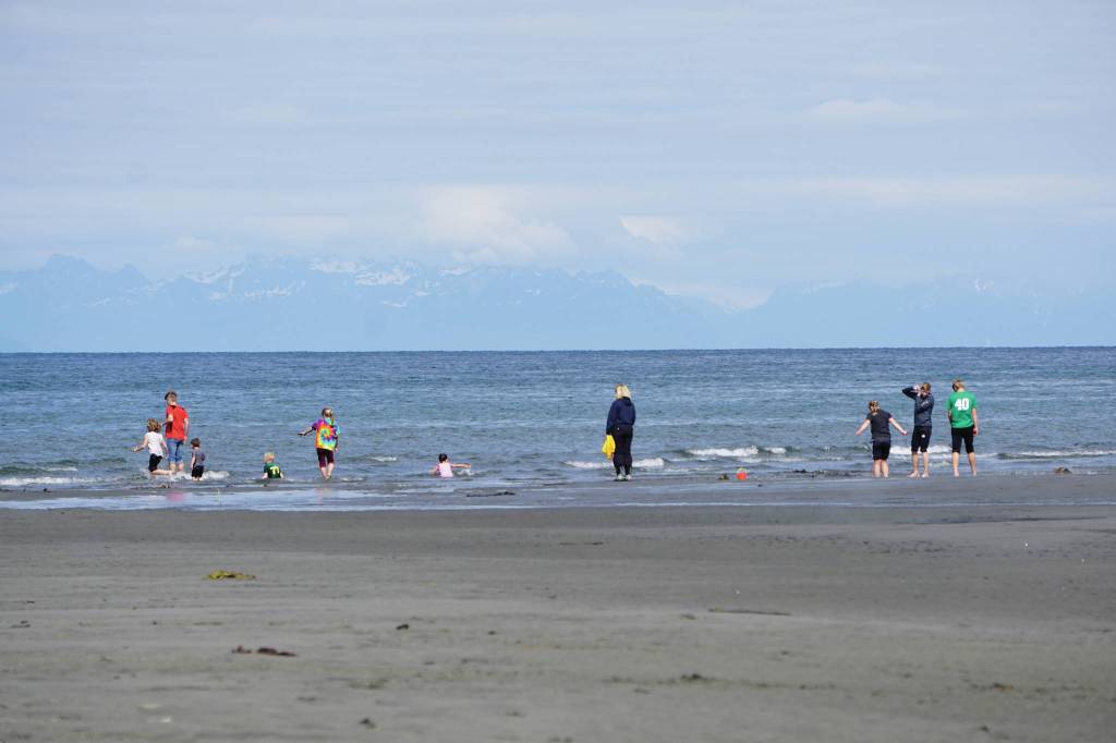 A family plays in the ocean on Saturday, June 20, 2020, at the beach in Anchor Point, Alaska. (Photo by Michael Armstrong/Homer News)