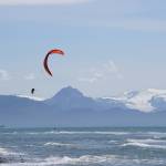 Two kiteboarders play in the wind and surf on Tuesday, June 30, 2020, off the Homer Spit in Homer, Alaska. (Photo by Michael Armstrong/Homer News)