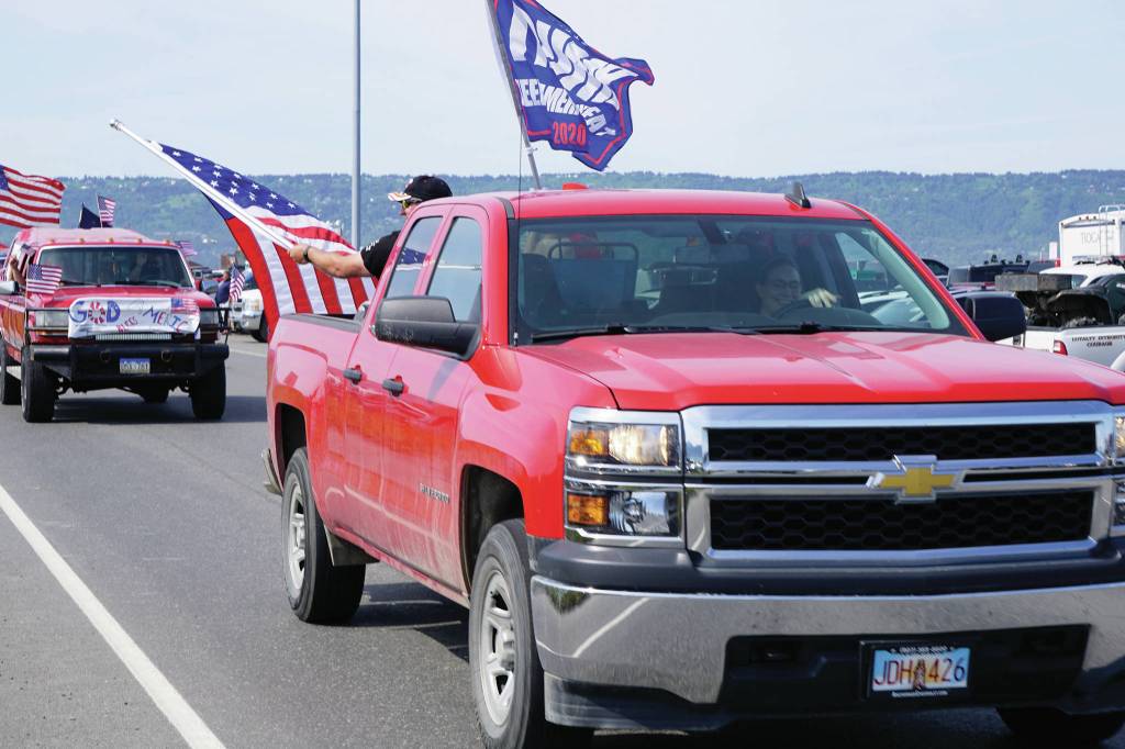 A woman drives a truck with a Trump 2020 flag on July 4, 2020, part of an Independence Day parade on Saturday, July 4, 2020 that went from Soundview Avenue on the Sterling Highway to the end of the Homer Spit in Homer, Alaska. (Photo by Michael Armstrong/Homer News)