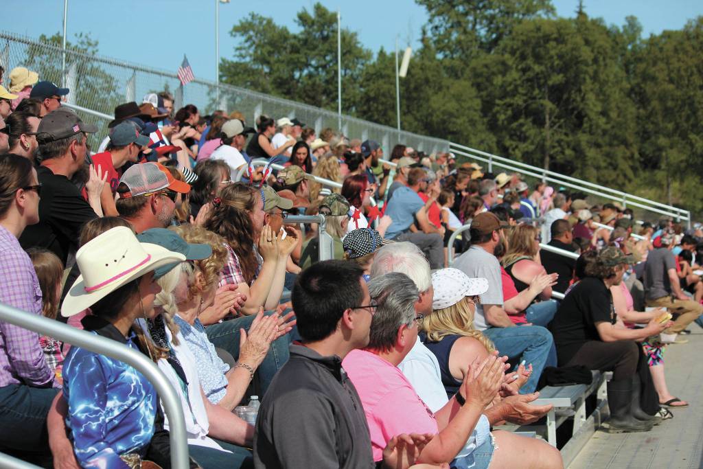 Members of the crowd at this years Ninilchik Rodeo cheer during an event Saturday, July 4, 2020 at the Kenai Peninsula Fairgrounds in Ninilchik, Alaska. The rodeo celebrated 60 years with a rooted in history theme. (Photo by Megan Pacer/Homer News)