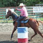 Naida McGee, of Anchorage, leads her horse through the barrel race at this years Ninilchik Rodeo on Saturday, July 4, 2020 at the Kenai Peninsula Fairgrounds in Ninilchik, Alaska. (Photo by Megan Pacer/Homer News)
