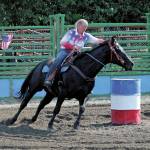 Katy Jones, of the Homer area, rides her horse Bo through a barrel race Saturday, July 4, 2020 during the Ninilchik Rodeo at the Kenai Peninsula Fairgrounds in Ninilchik, Alaska. (Photo by Megan Pacer/Homer News)
