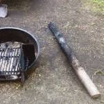 Photo provided by Kenai National Wildlife Refuge                                 A smoldering tree sits outside the fire ring as proof that green trees do not make good firewood but do increase wildfire risk.
