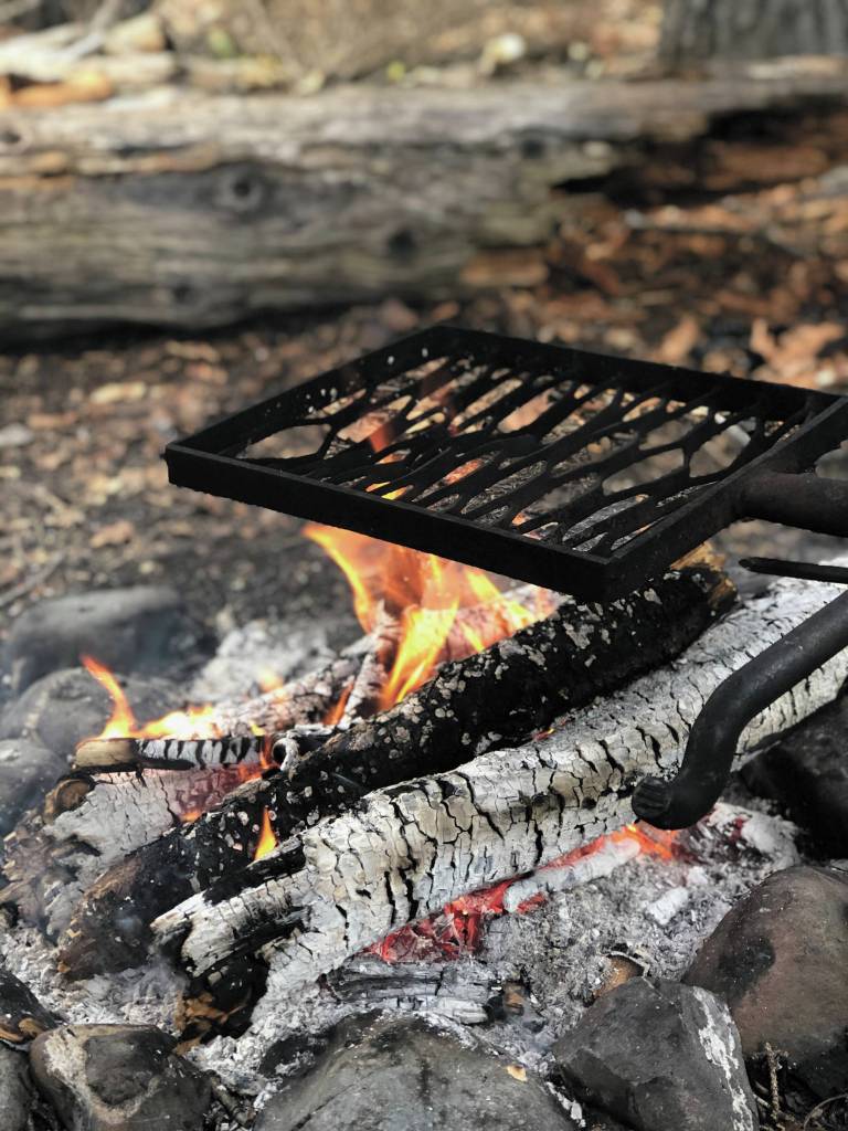 Embers ideal for cooking smores smolder away on June 27, 2020 at a campsite along the Resurrection Pass Trail in Cooper Landing, Alaska. (Photo by Megan Pacer/Homer News)