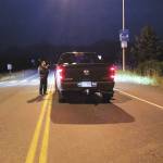 NOAA officer Britt Haney stops a truck from going onto the Homer Spit in the early morning hours of Wednesday, July 22, 2020 in Homer, Alaska. Homer residents were asked to evacuate certain areas of the city following a 7.8 magnitude earthquake off the Aleutian Chain that triggered a tsunami warning. (Photo by Megan Pacer/Homer News)