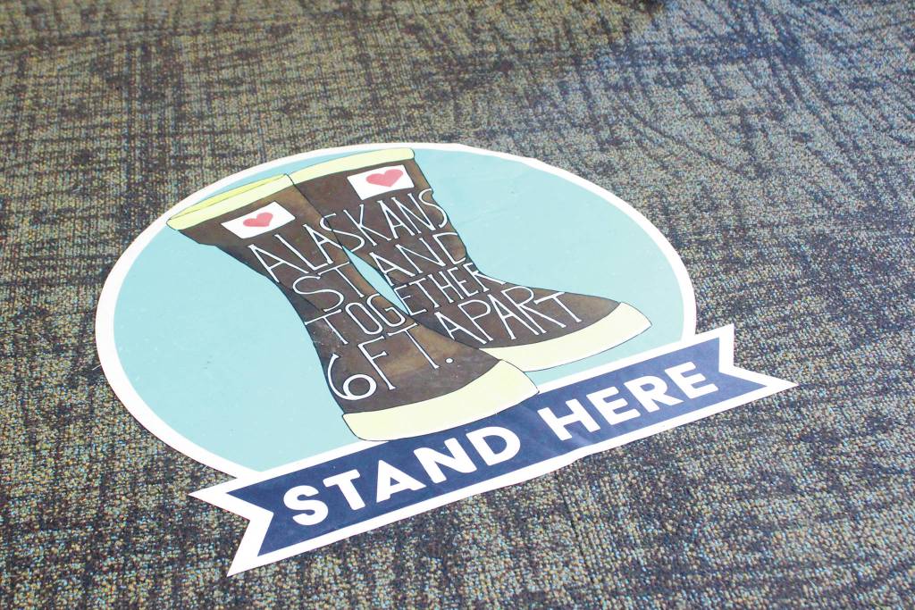 A floor marker shows voters where to stand to maintain a safe distance between each other during the Primary Election on Tuesday, Aug. 18, 2020 at Homer City Hall in Homer, Alaska. (Photo by Megan Pacer/Homer News)