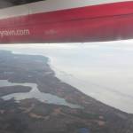 Cook Inlet can be seen through the window of a Ravn aircraft in October 2019. RavnAir Group declared bankruptcy in April. (Photo by Erin Thompson/Peninsula Clarion)