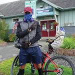 Karim Otky, 43, of Morocco and Sarasota, Florida, poses in front of the Homer Chamber of Commerce and Visitor Center on Thursday, Aug. 13, 2020, in Homer, Alaska. Otky rode his bicycle from north of Fairbanks to Homer after first flying to Anchorage three weeks ago from Juneau. A resident of the United States since 1999, Otky is a professional tennis coach and athletic trainer biking around the world. He also has worked with children in conflict countries in Saharan Africa  and suffered a machete attack because of his work. Its very important to empower the children, he said. Otky has been biking around the world since 2018 and has been from Vancouver, British Columbia, to Las Vegas, and through the western Lower 48 states, including Colorado, Wyoming and Utah. Someone shot at him five times in Rock Spring, Wyoming, hitting his bike and narrowly missing him, he said. After the attack he kept going even though police offered him counseling after his trauma. The power of sports kept me going biking, Otky said. I said, I just want to ride. Its an important message how sports keeps you free.