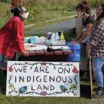 Melissa Shaginoff, right, speaks with Rika Mouw, left, and Asia Freeman, center, at Land Acknowledgement in Action: Sign Installation last Saturday, Aug. 22, 2020, at the Bishops Beach pavillion  the area known by the Denaina people as Tuggeht, or at the waters edge. (Photo by Michael Armstrong/Homer News.