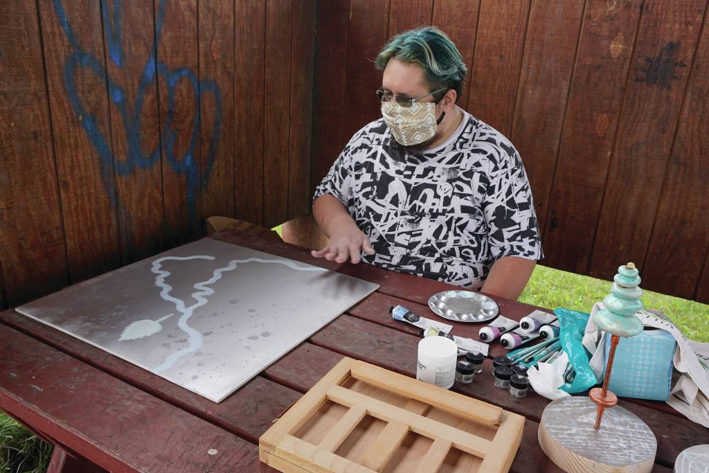 Argent Kvasnikoff of Ninilchik discusses a sign hes painting at Land Acknowledgement in Action: Sign Installation last Saturday, Aug. 22, 2020, at the Bishops Beach pavillion  the area known by the Denaina people as Tuggeht, or at the waters edge. (Photo by Michael Armstrong/Homer News.