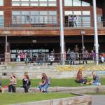 Homer High School students finish eating lunch outside the school while others make their way back into the building for the next class period on Monday, Aug. 24, 2020 in Homer, Alaska. (Photo by Megan Pacer/Homer News)