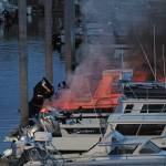 Flames and smoke rise from a 32-foot fiberglass boat docked in the Homer Harbor on the evening of Friday, Sept. 11, 2020 in Homer, Alaska. No one was harmed and the Homer Volunteer Fire Department put out the fire. (Photo by Megan Pacer/Homer News)
