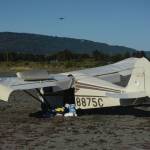 A crashed Piper 22-135 single-engine airplane lies on the mud flats of Mariner Park Slough at about 5:30 p.m. Sunday, Sept. 13, 2020, after it crashed about 45 minutes earlier on takeoff near the Homer, Alaska, Airport. The pilot and only person on board suffered minor injuries. (PHoto by Michael Armstrong/Homer News)
