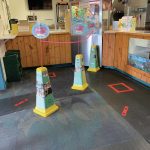 Modifications to the Homer Theatre lobby including 6-foot distancing marks and plastic shields at the concession counter, as seen here in this photo taken Sept. 14, 2020, at the movie theater in Homer, Alaska. (Photo courtesy of Homer Theatre)